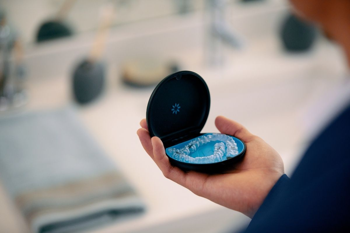 Close-up of an Invisalign clear aligner sitting in its branded carrying case — precision-crafted custom aligners