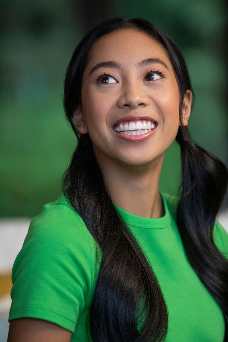 Woman smiling confidently — a beautiful smile starts with properly aligned teeth before cosmetic dental work